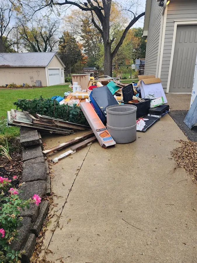 Dumpster being loaded with debris for Roofing Dumpster Rental in Red Springs